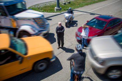 Man standing in front of vehicles